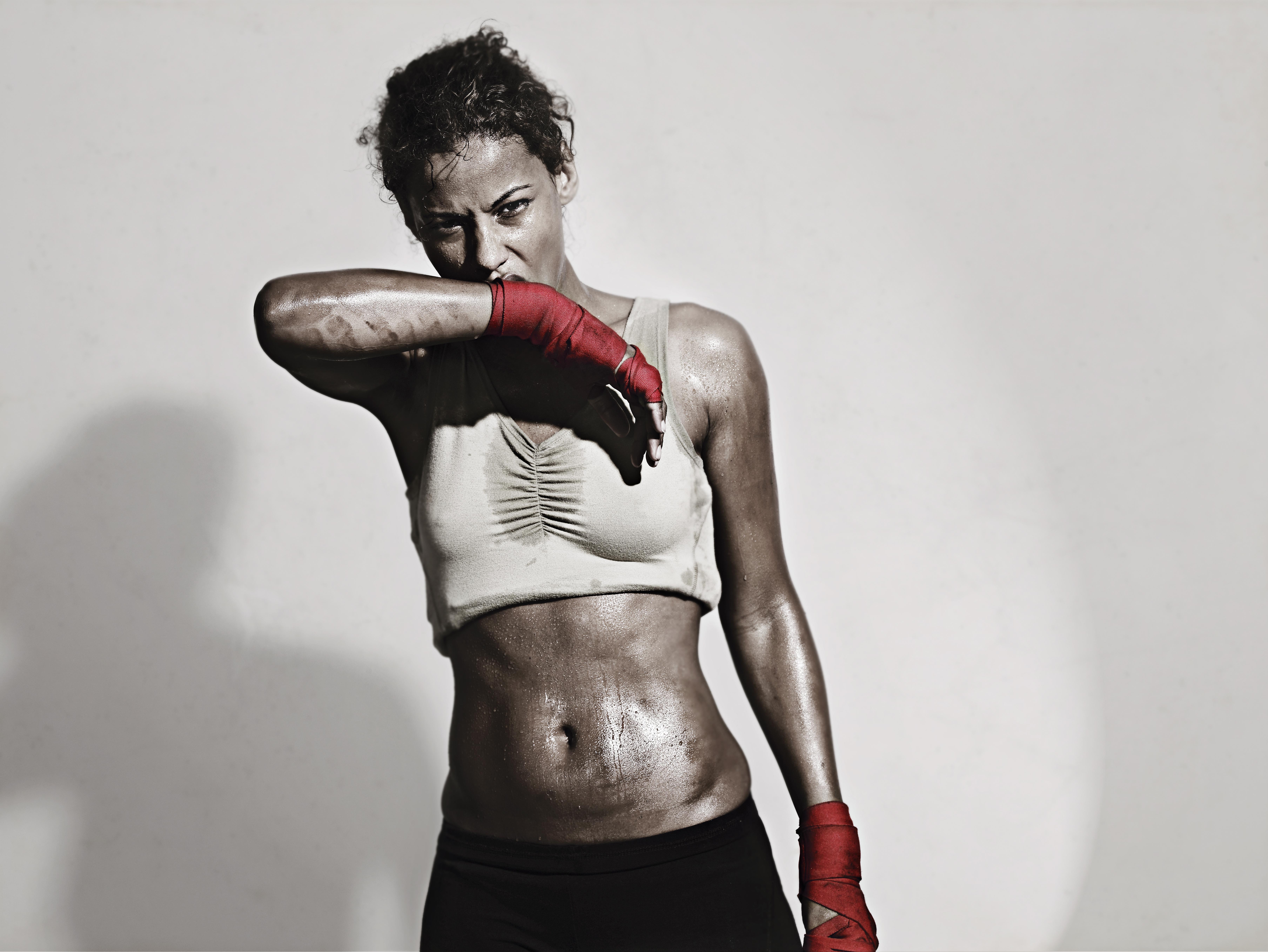 Female Boxer wiping off the sweat from her face