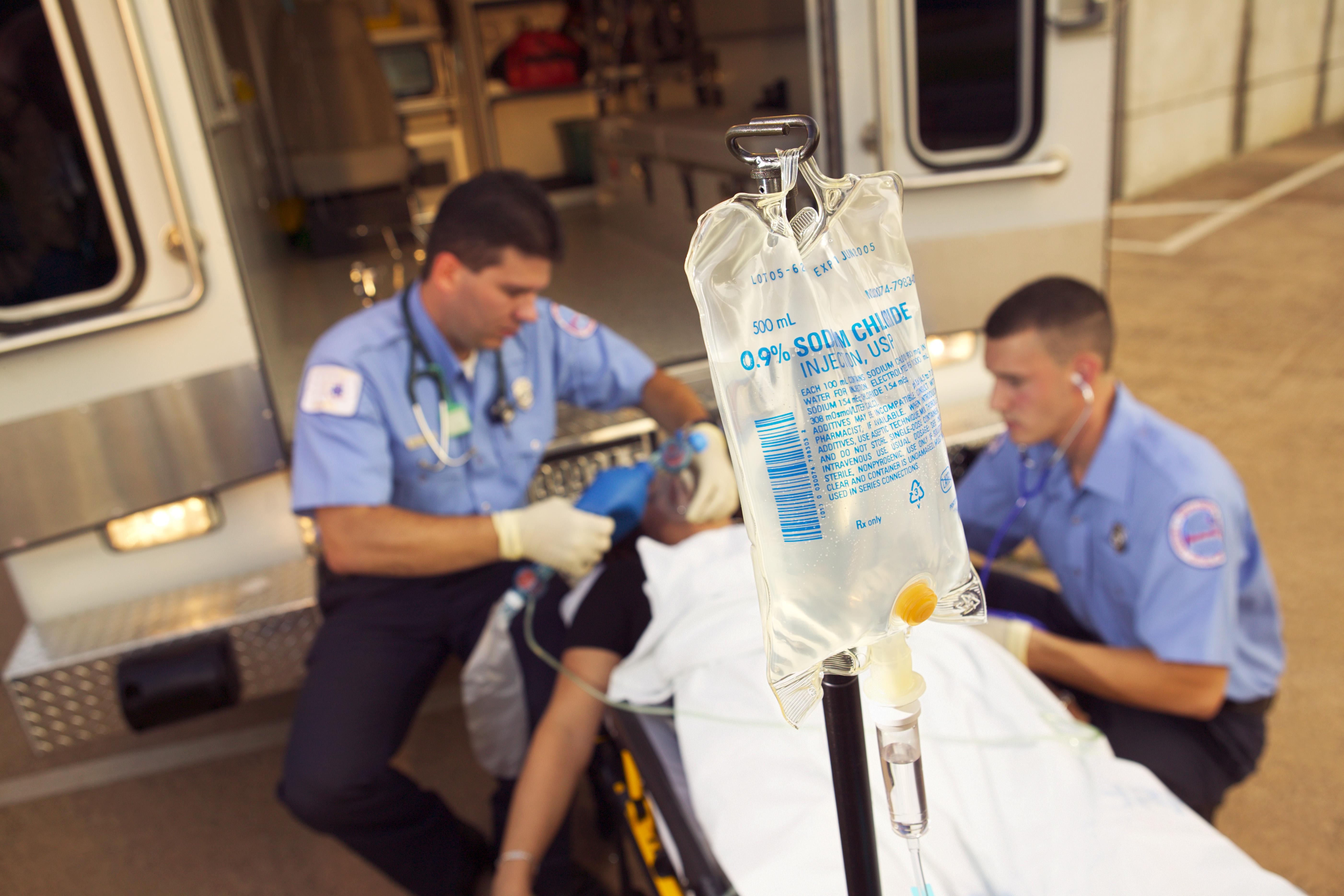 Paramedics loading patient into ambulance