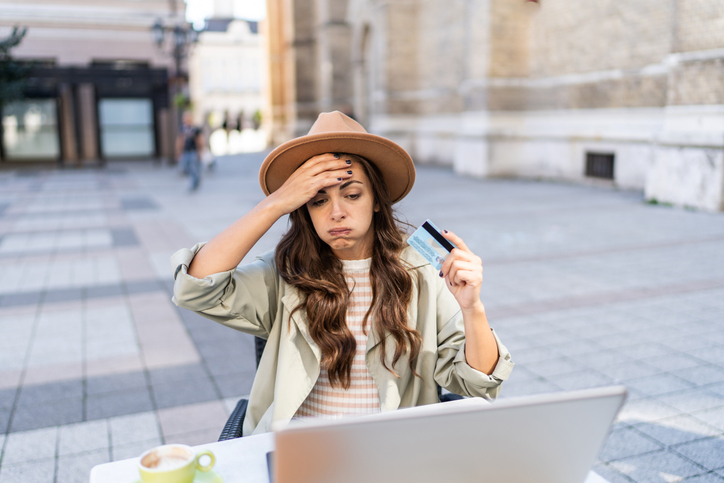Stressed young woman having online payment problems with credit card
