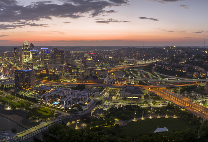 Cincinnati Ohio urban architecture in city downtown at night. Panoramic view of business district skyline with high-rise buildings at nightfall