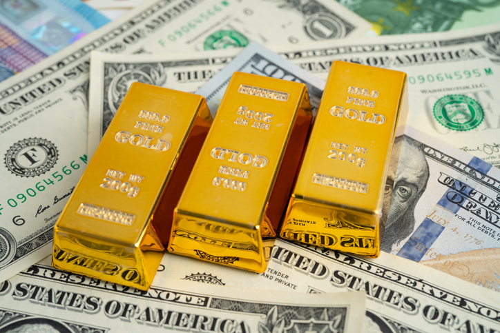 Gold bar on US dollar and Euro banknote, economy finance exchange trade investment.